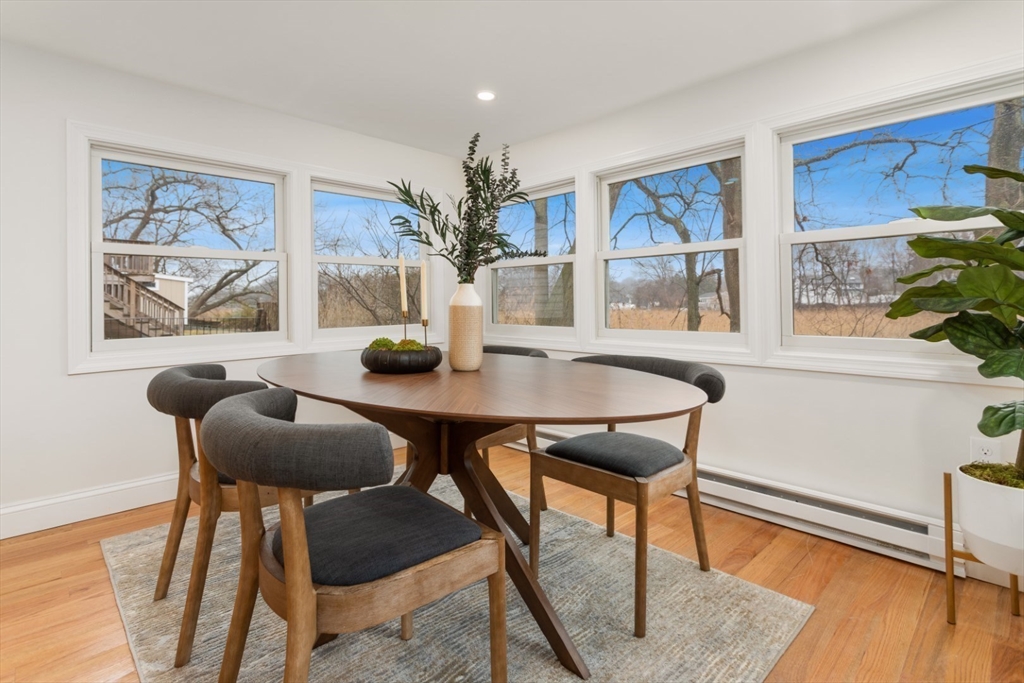 83 Riverbank Road Saugus, MA 01906 - Photo 19 of 36 a view of a dining room with furniture and wooden floor