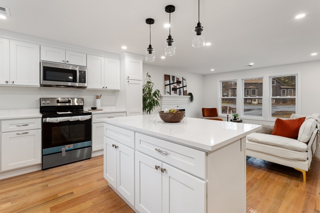 83 Riverbank Road Saugus, MA 01906 - Photo 2 of 36 a kitchen with stainless steel appliances kitchen island granite countertop a sink and cabinets