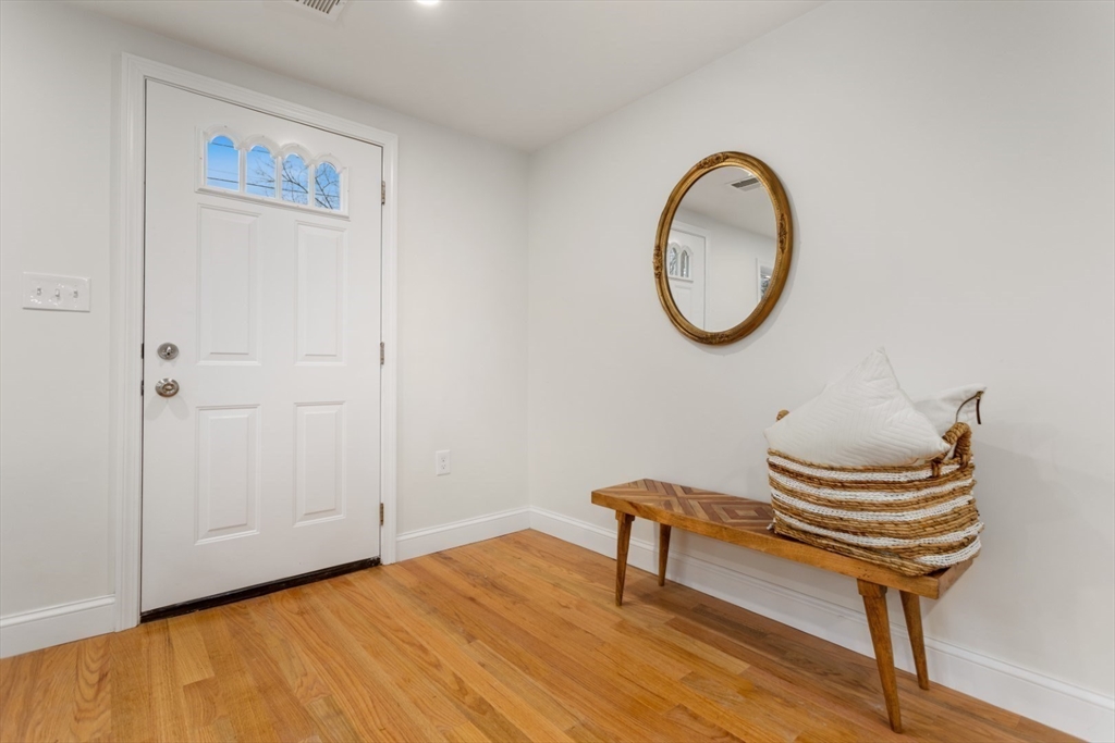 83 Riverbank Road Saugus, MA 01906 - Photo 21 of 36 a bench sitting in a room next to a chair