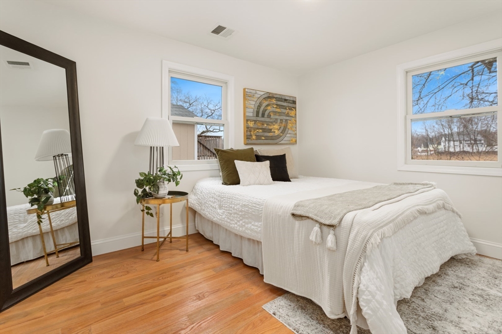 83 Riverbank Road Saugus, MA 01906 - Photo 25 of 36 a bedroom with a bed and a painting on the wall