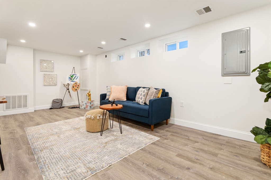 83 Riverbank Road Saugus, MA 01906 - Photo 30 of 36 a living room with furniture and a couch