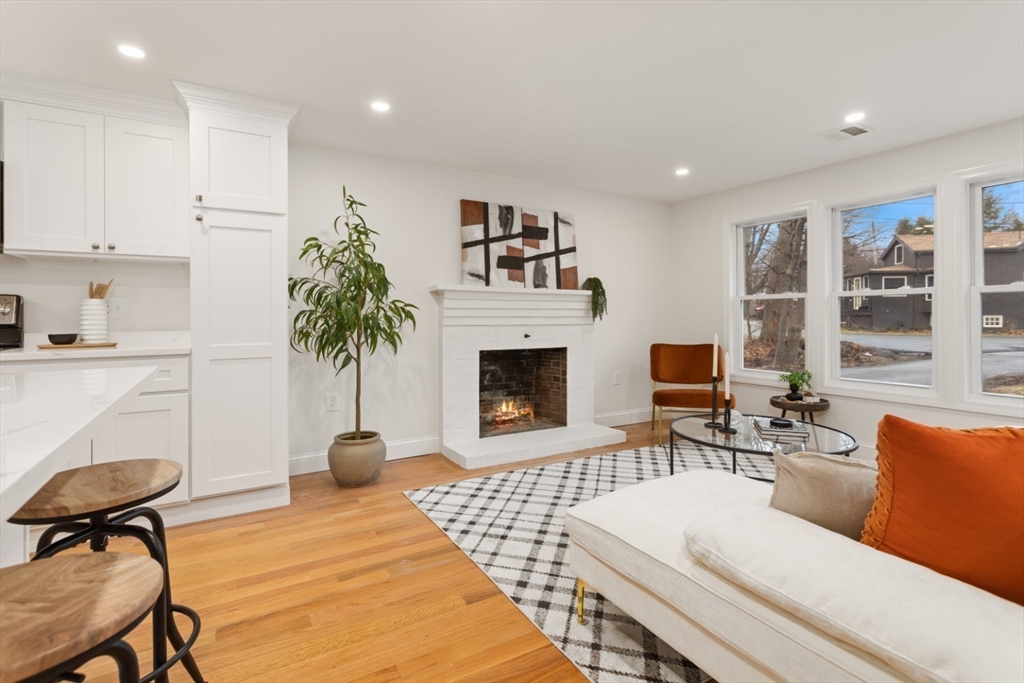 83 Riverbank Road Saugus, MA 01906 - Photo 5 of 36 a living room with furniture a window and a fireplace