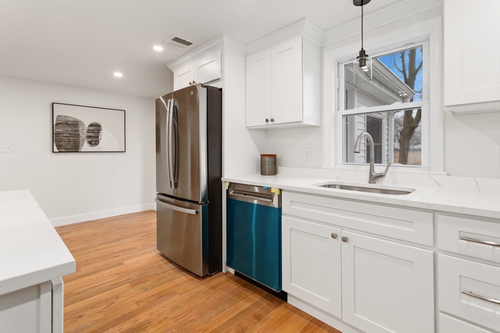 83 Riverbank Road Saugus, MA 01906 - Photo 6 of 36 a kitchen with a refrigerator sink and cabinets