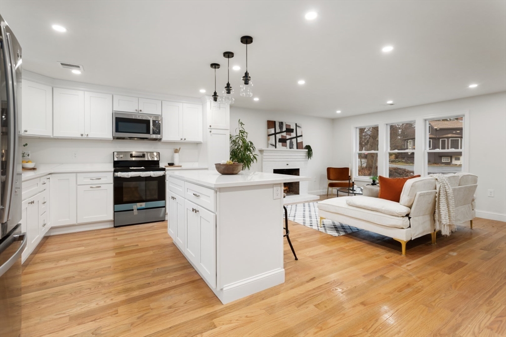 83 Riverbank Road Saugus, MA 01906 - Photo 7 of 36 a kitchen with white cabinets and stainless steel appliances
