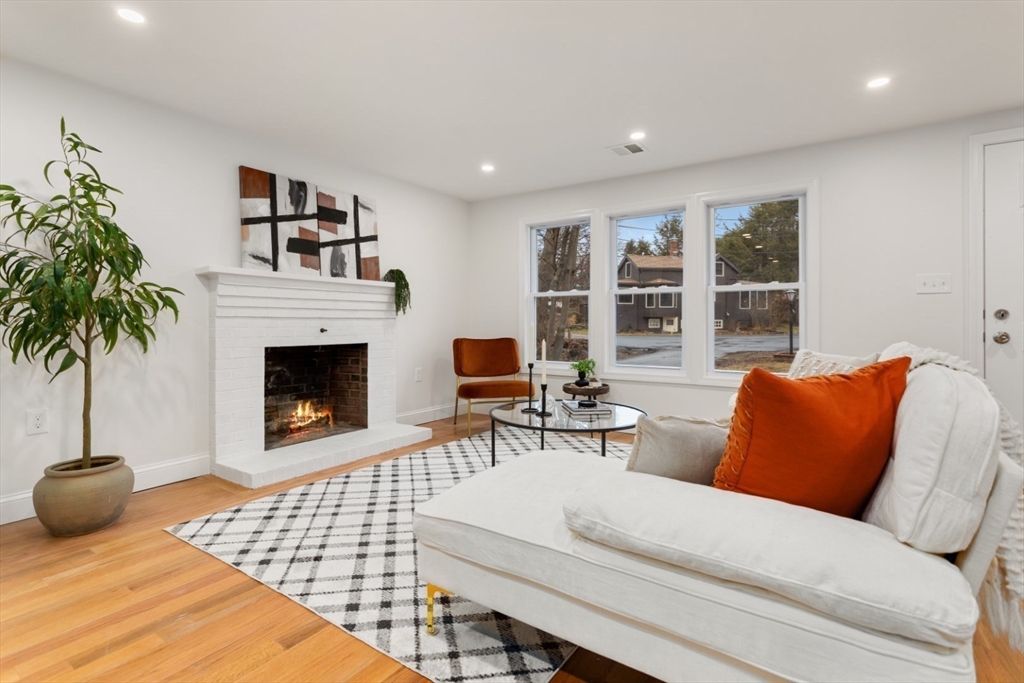 83 Riverbank Road Saugus, MA 01906 - Photo 8 of 36 a living room with furniture a rug and a fireplace