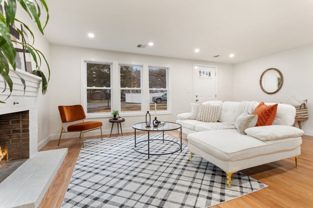 83 Riverbank Road Saugus, MA 01906 - Photo 9 of 36 a living room with furniture and a fireplace