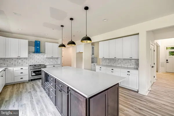 a kitchen with stainless steel appliances a stove a refrigerator and a sink