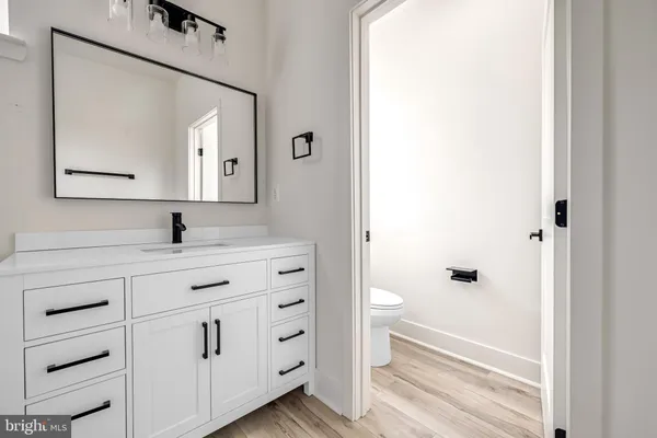 a bathroom with a double vanity sink mirror and bathtub