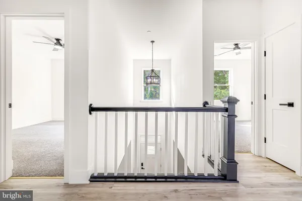 a view of a room with wooden floor and windows