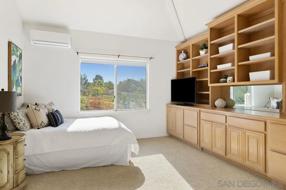 14331 Twisted Branch Road Poway, CA 92064 - Photo 17 of 25 a bedroom with a large bed and a flat tv screen on the dresser