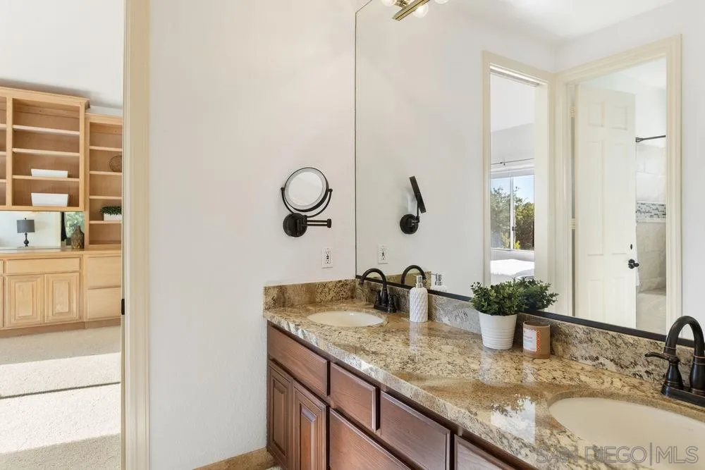 14331 Twisted Branch Road Poway, CA 92064 - Photo 18 of 25 a bathroom with a granite countertop sink and a mirror