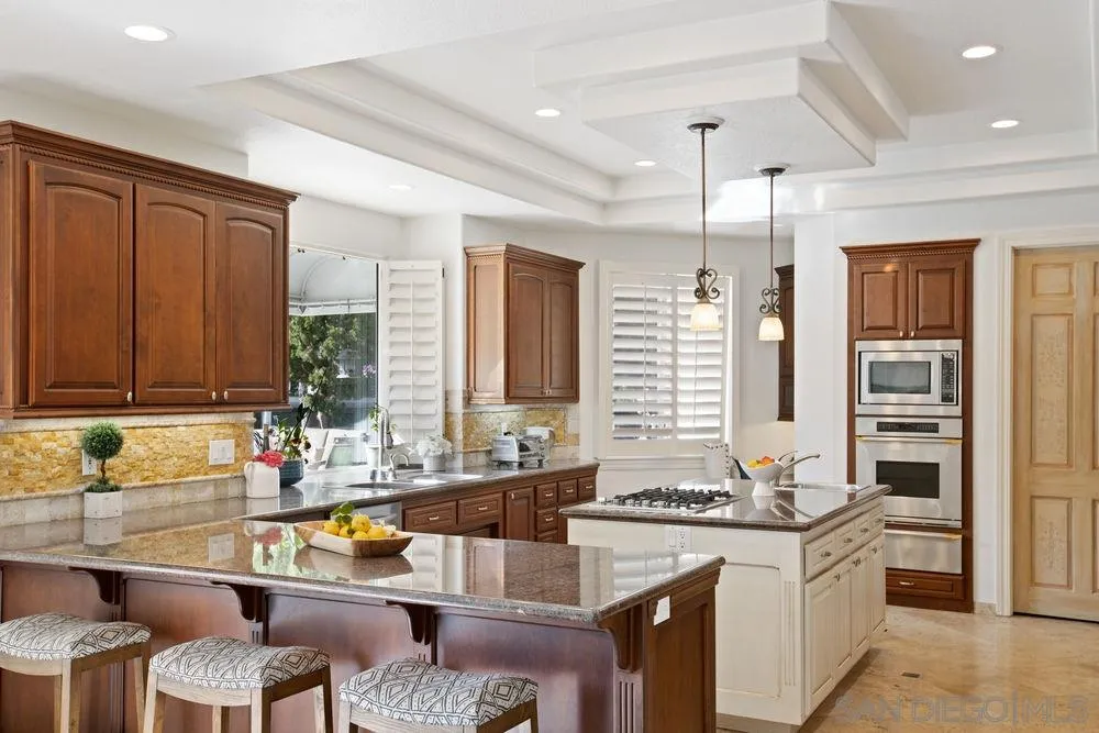 14331 Twisted Branch Road Poway, CA 92064 - Photo 7 of 25 a kitchen with a sink stove and chairs