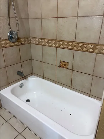 a bathroom with a bathtub and shower