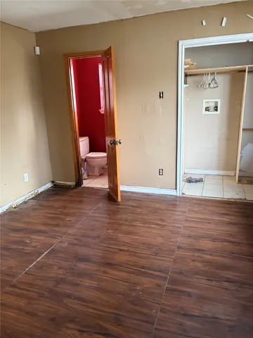 a view of a room with wooden floor and window
