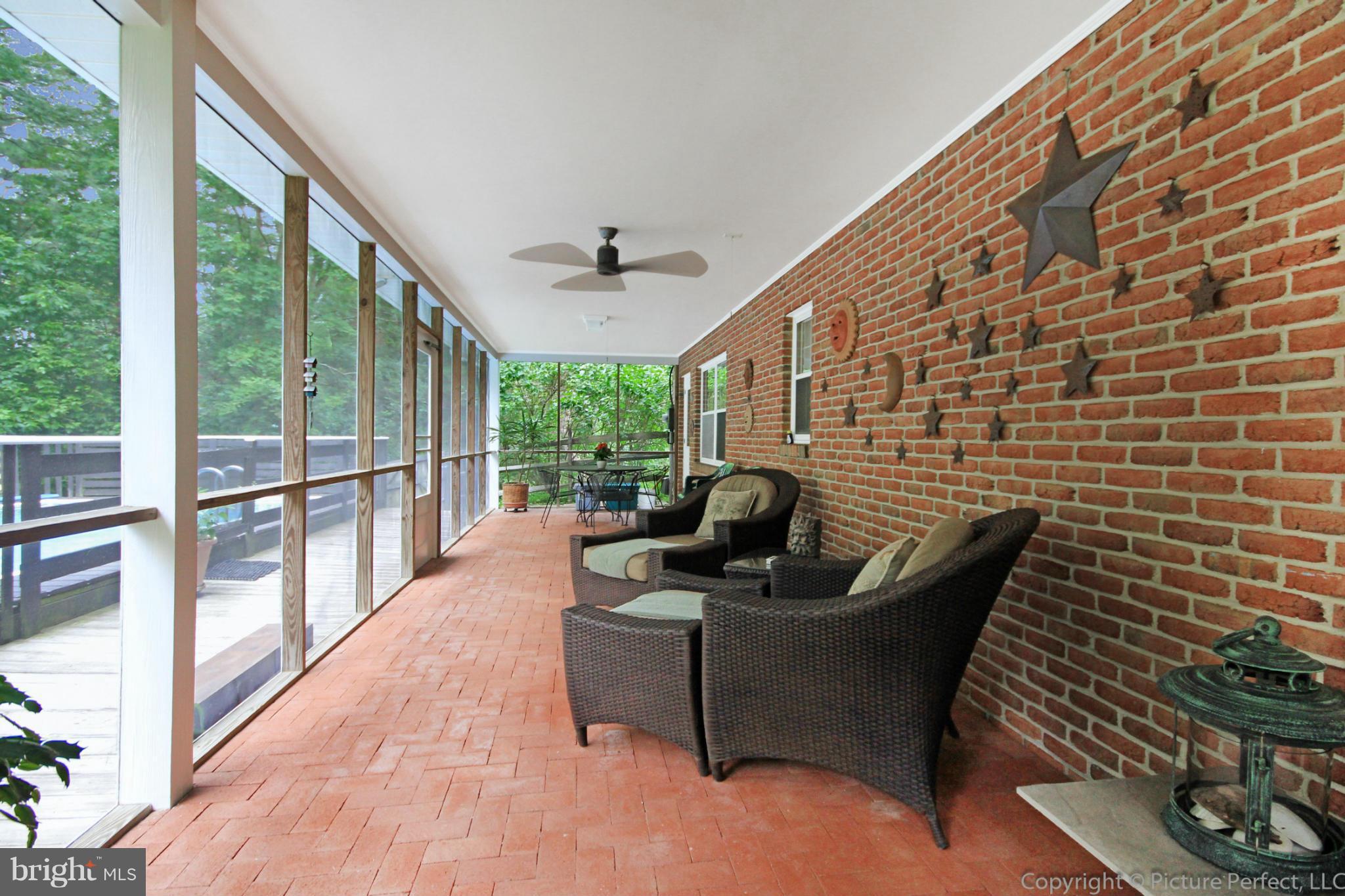 8309 Palmer Road Middletown, MD 21769 - Photo 22 of 29 a living room with furniture and a floor to ceiling window