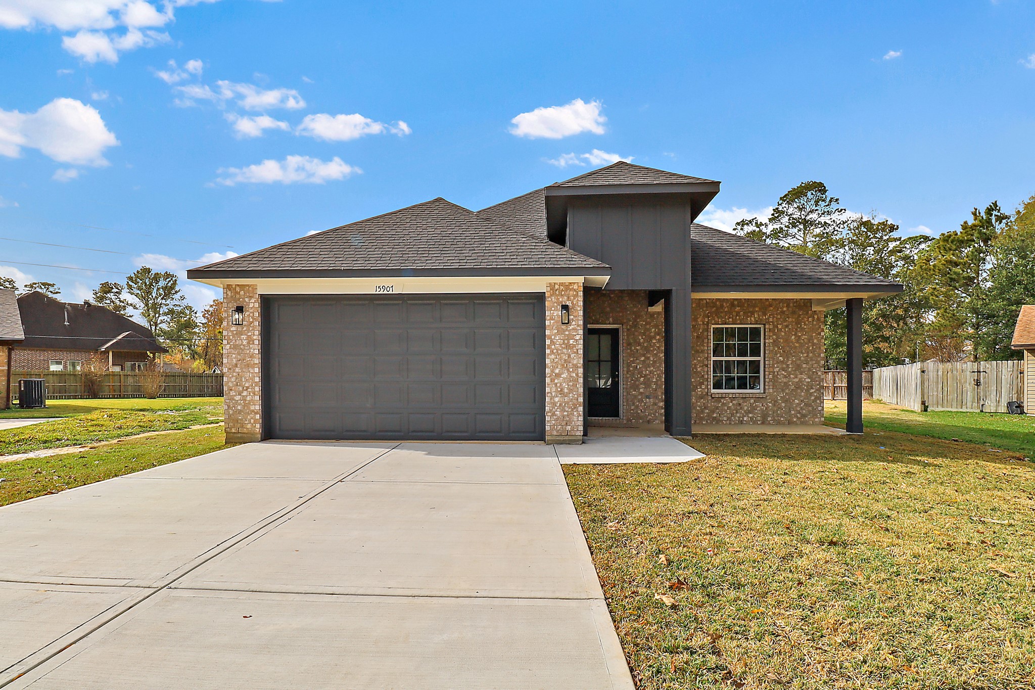 15907 Castaway Court Crosby, TX 77532 - Photo 1 of 26 a front view of a house with a yard and garage