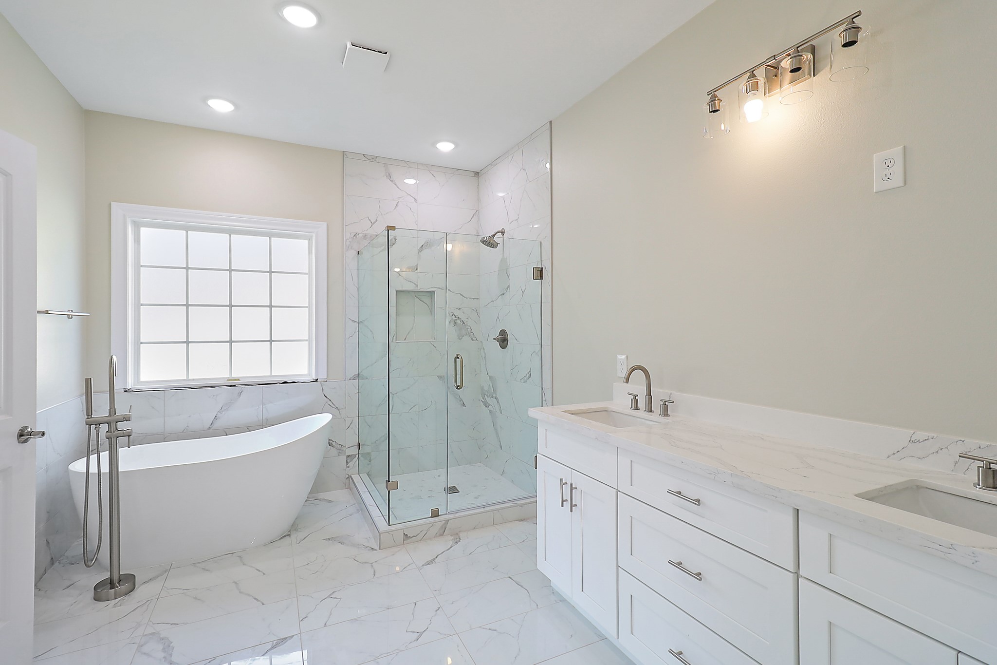 15907 Castaway Court Crosby, TX 77532 - Photo 15 of 26 a spacious bathroom with a double vanity sink a mirror and a bathtub