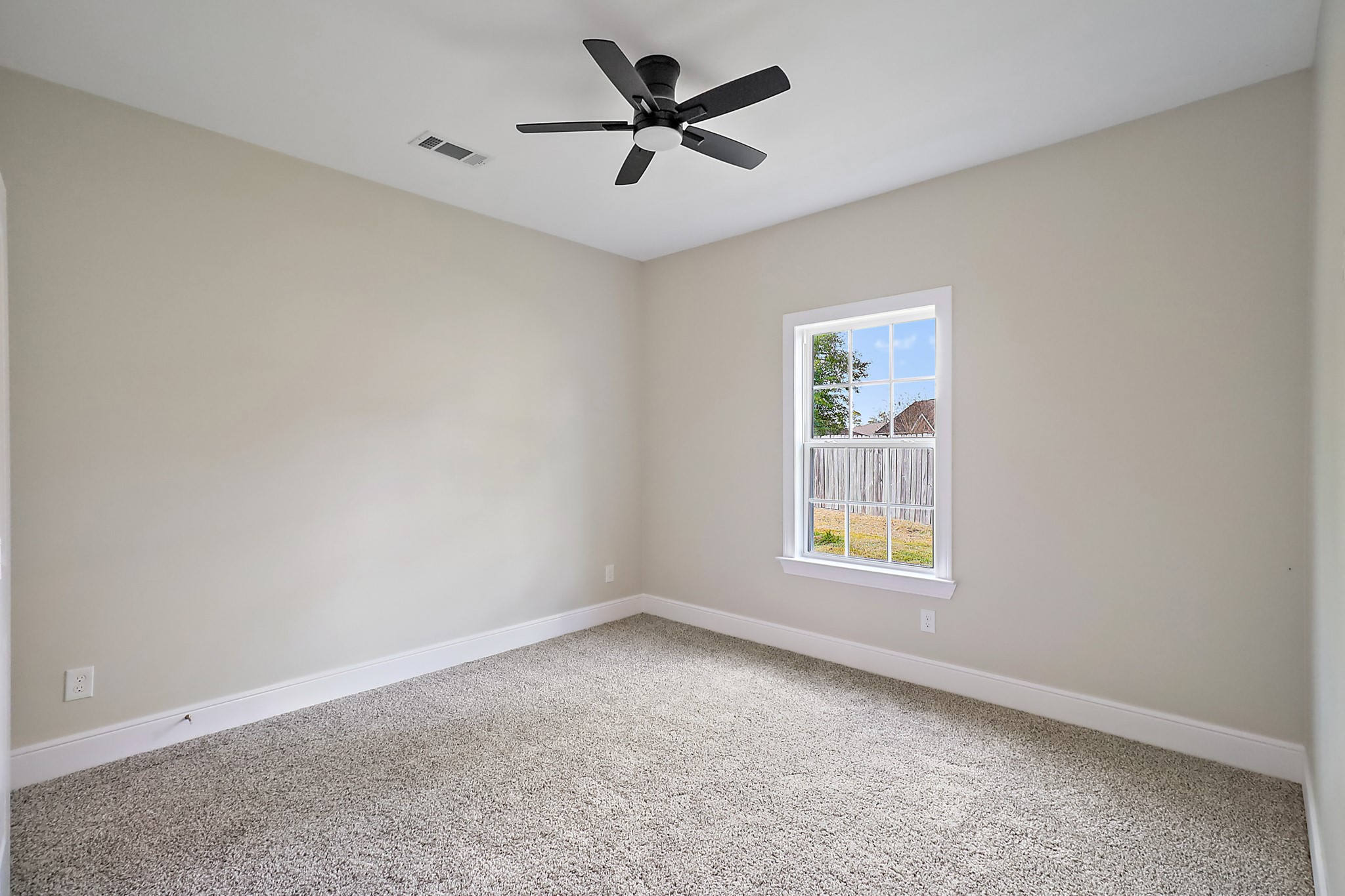 15907 Castaway Court Crosby, TX 77532 - Photo 19 of 26 an empty room with a window and a ceiling fan