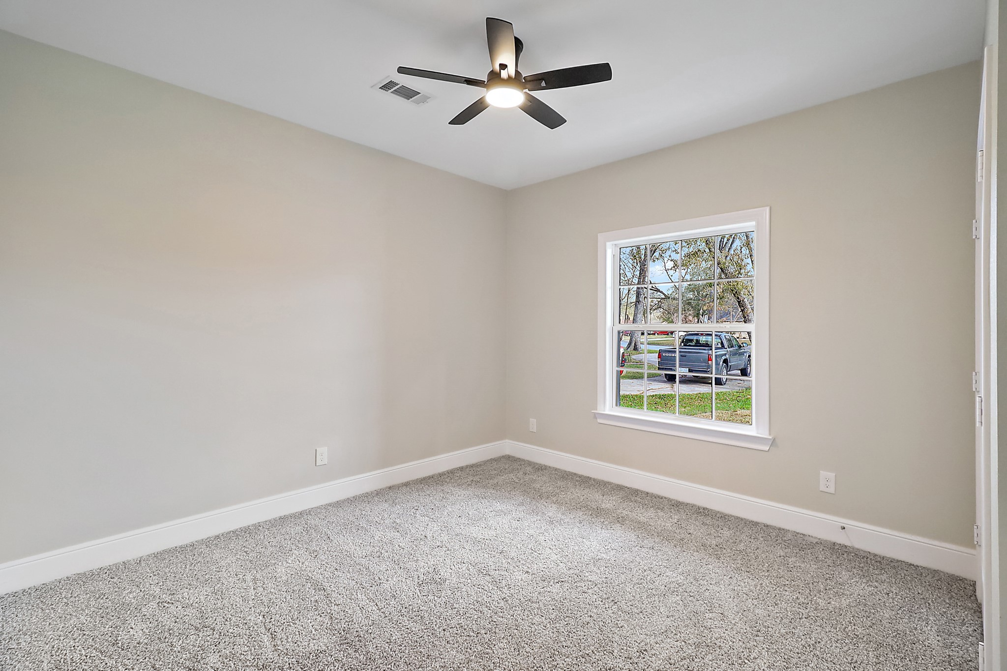 15907 Castaway Court Crosby, TX 77532 - Photo 20 of 26 an empty room with a window and a fan