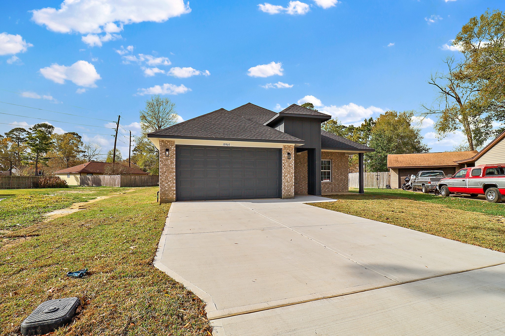 15907 Castaway Court Crosby, TX 77532 - Photo 2 of 26 a front view of a house with a garden and yard