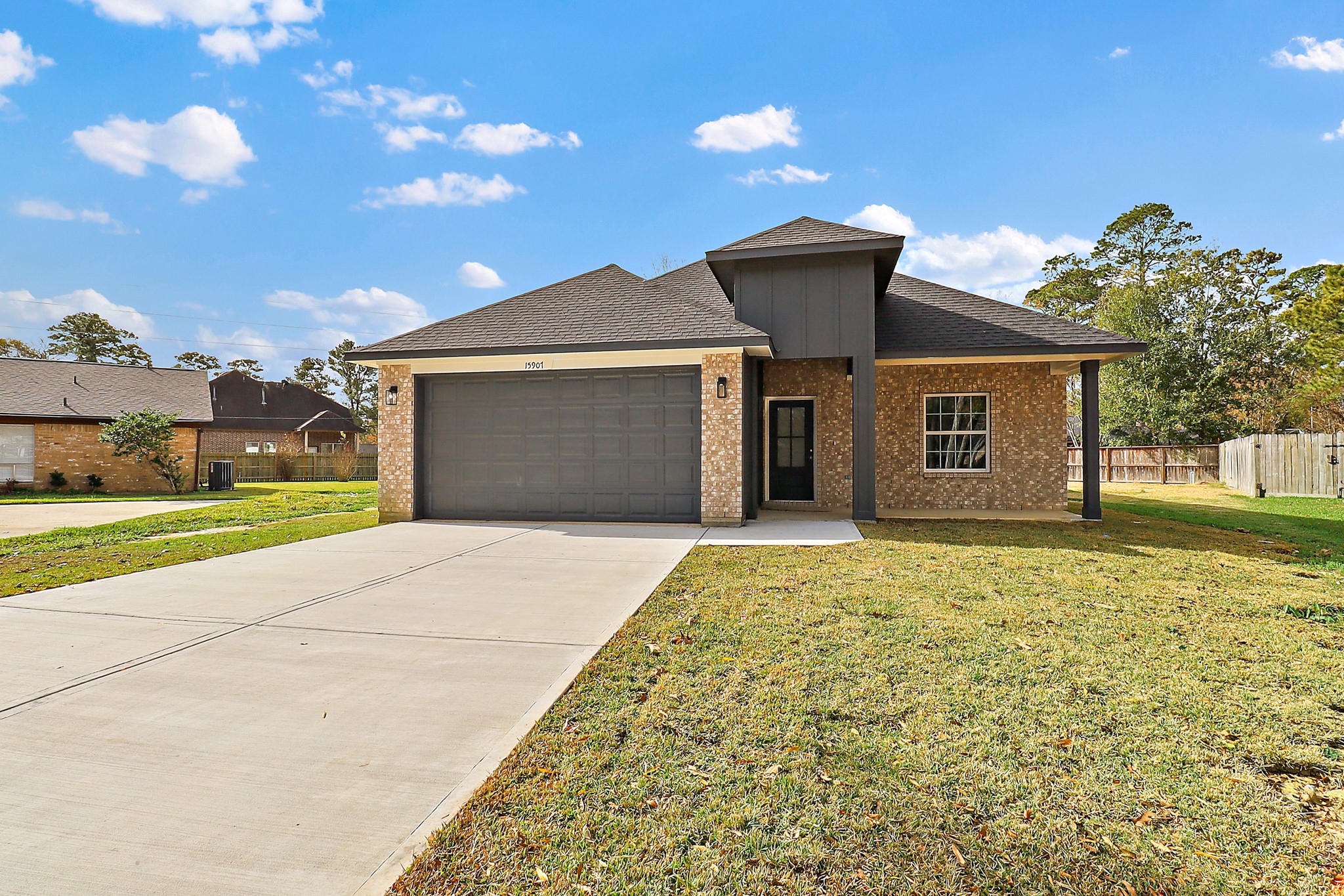 15907 Castaway Court Crosby, TX 77532 - Photo 24 of 26 a front view of a house with a yard and garage