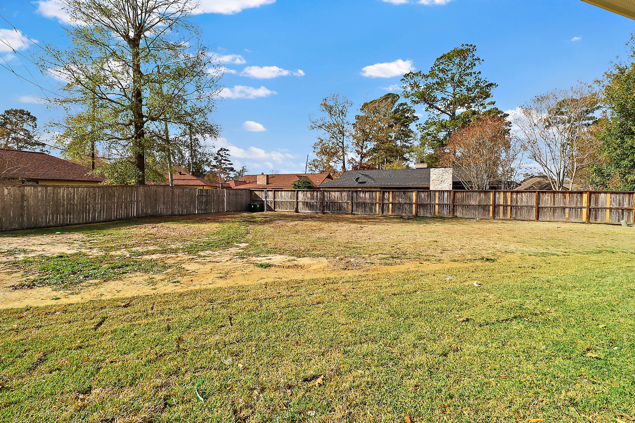 15907 Castaway Court Crosby, TX 77532 - Photo 25 of 26 a swimming pool that has lawn chairs with wooden fence