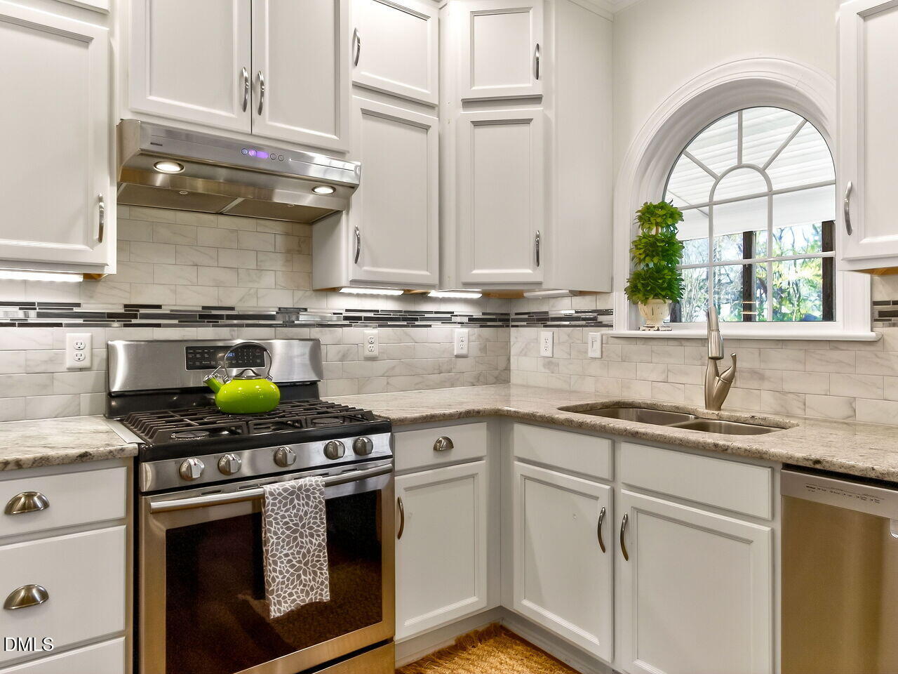 6104 Wolverhampton Drive Raleigh, NC 27603 - Photo 10 of 35 a kitchen with stainless steel appliances granite countertop a stove a sink and a granite counter tops