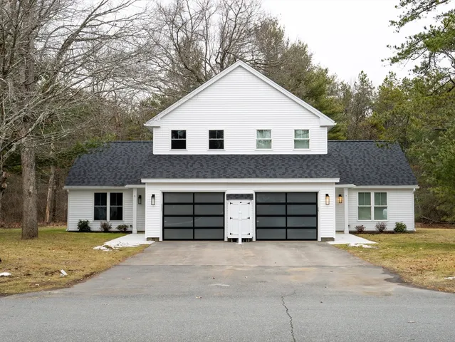 a view of a house with a yard and garage
