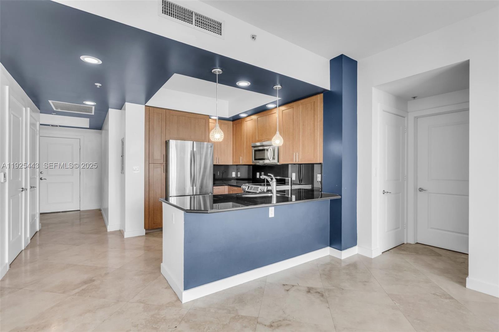 315 Northeast 3rd Avenue, Unit 1805 Fort Lauderdale, FL 33301 - Photo 12 of 43 a kitchen with stainless steel appliances kitchen island granite countertop a refrigerator and a sink