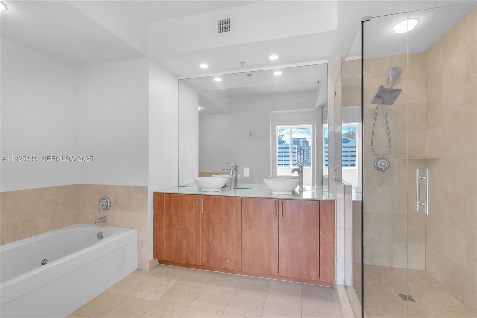 315 Northeast 3rd Avenue, Unit 1805 Fort Lauderdale, FL 33301 - Photo 20 of 43 a bathroom with a bathtub and a shower