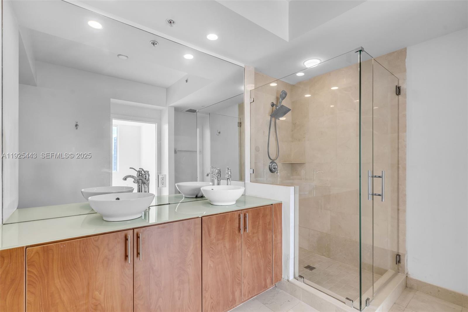 315 Northeast 3rd Avenue, Unit 1805 Fort Lauderdale, FL 33301 - Photo 22 of 43 a bathroom with a double vanity sink mirror and shower