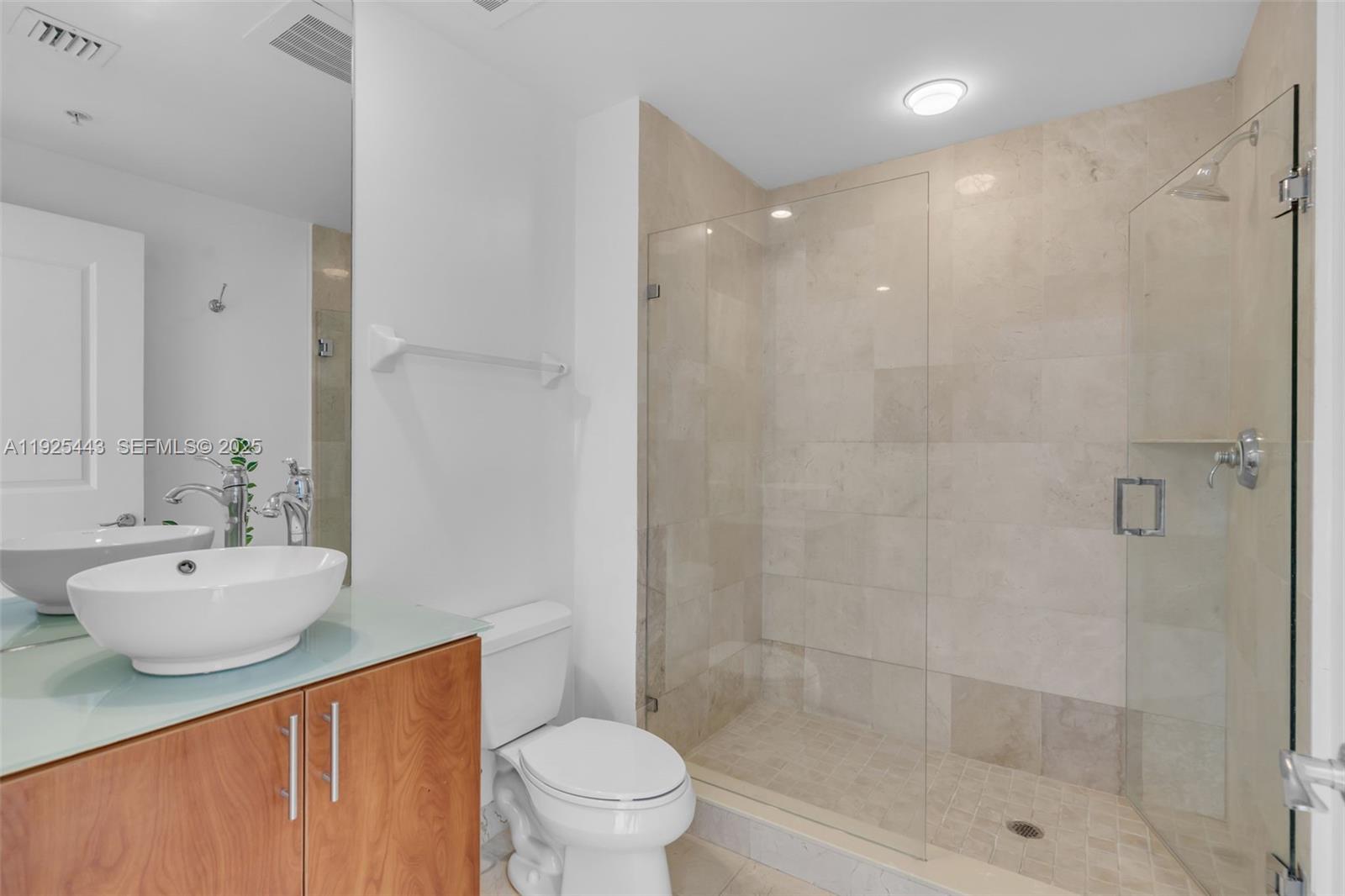 315 Northeast 3rd Avenue, Unit 1805 Fort Lauderdale, FL 33301 - Photo 23 of 43 a bathroom with a sink a toilet and shower