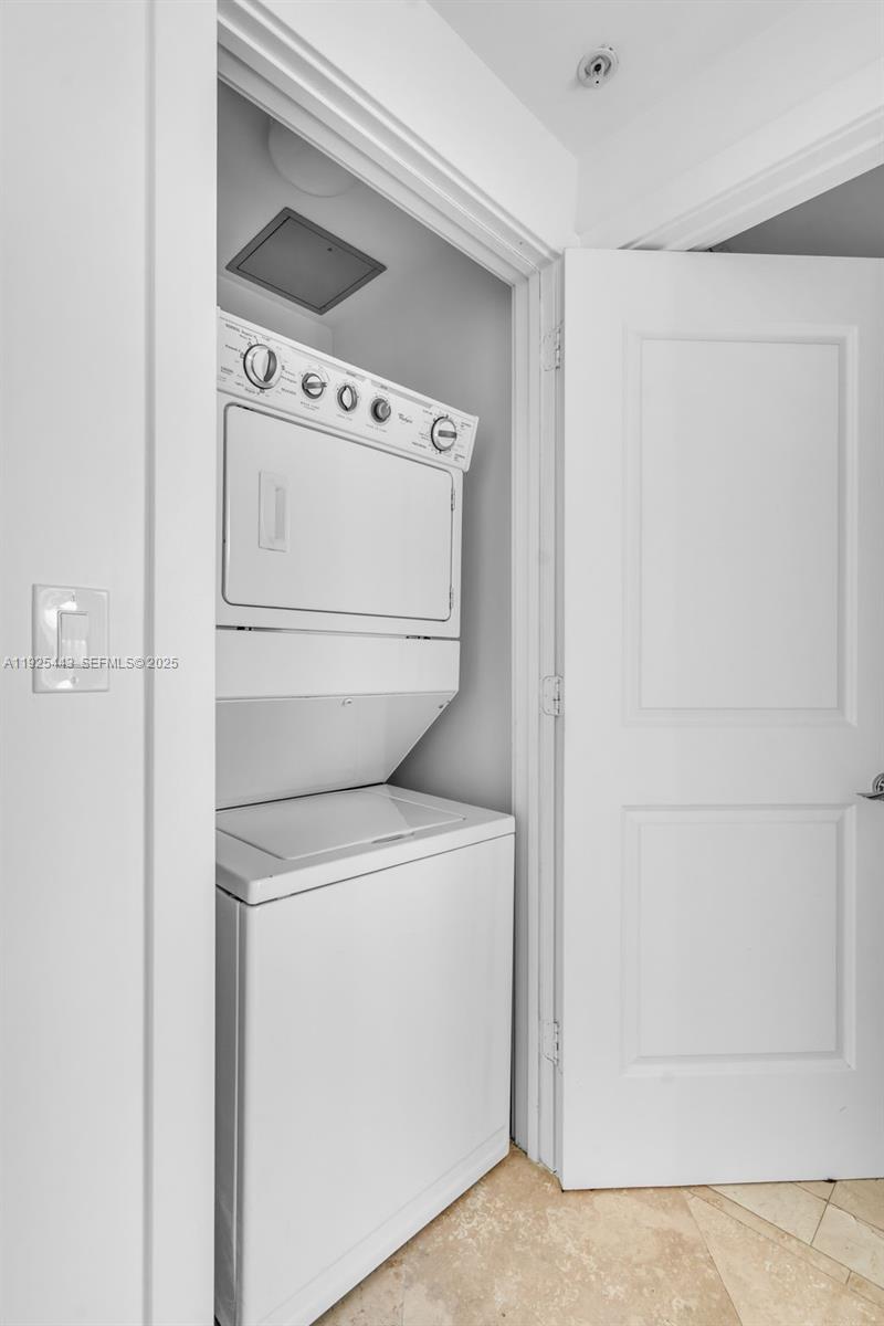 315 Northeast 3rd Avenue, Unit 1805 Fort Lauderdale, FL 33301 - Photo 26 of 43 a view of washer and dryer with kitchen in the background