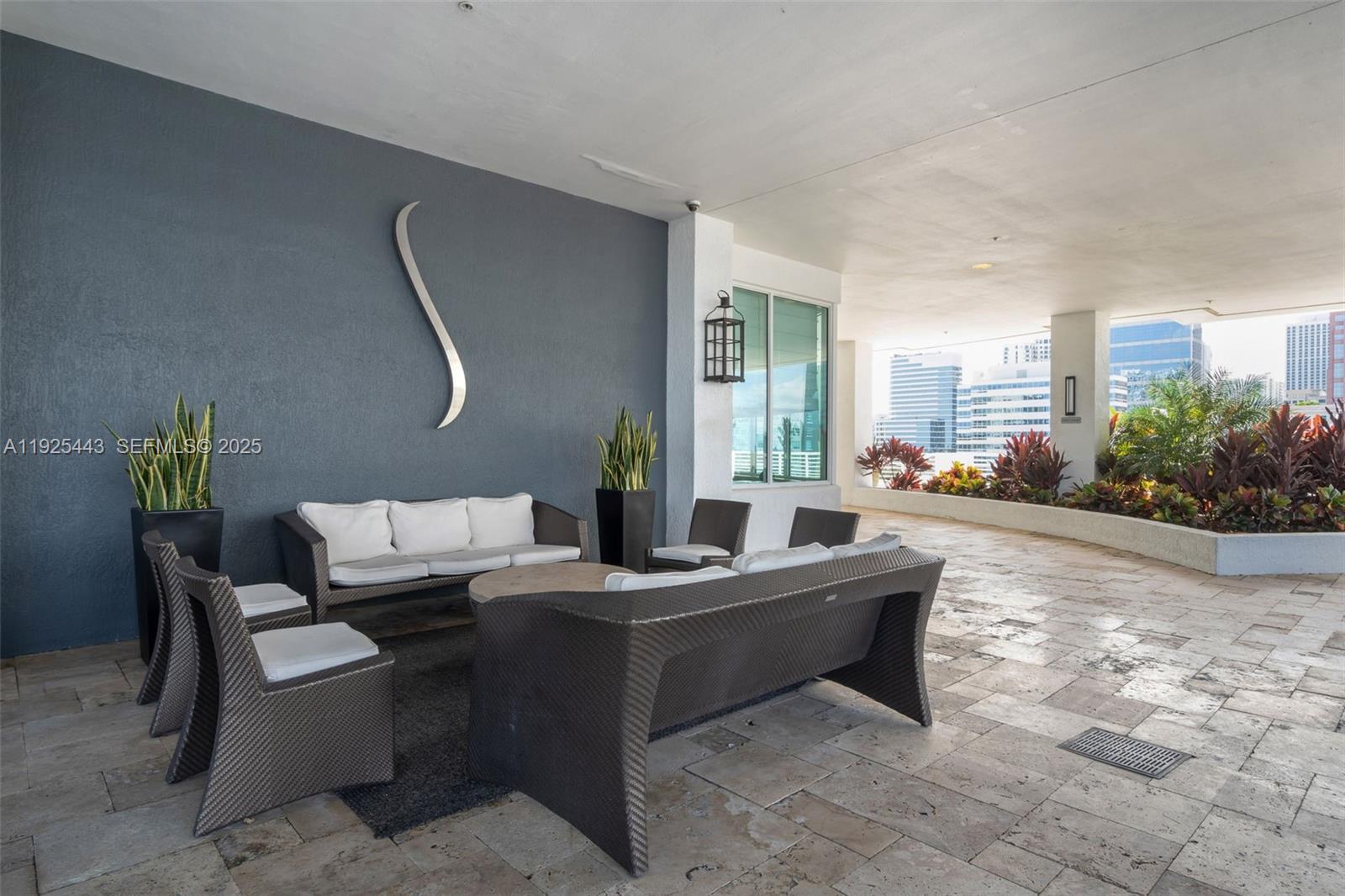 315 Northeast 3rd Avenue, Unit 1805 Fort Lauderdale, FL 33301 - Photo 32 of 43 a living room with furniture and a potted plant