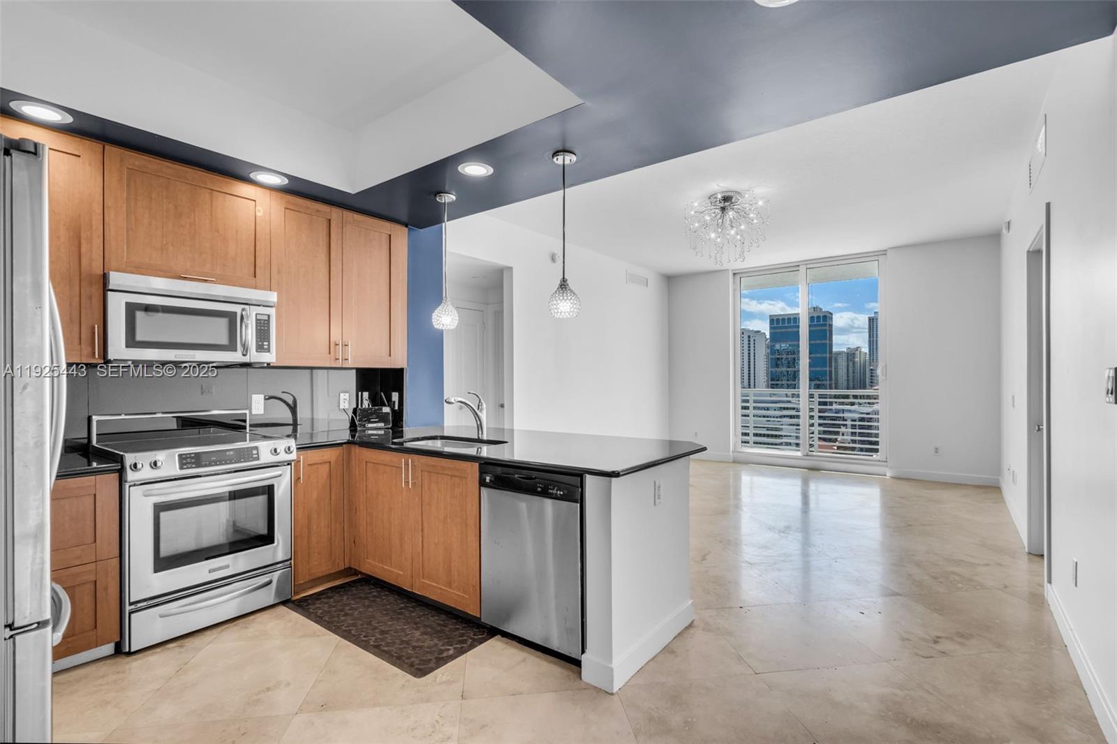 315 Northeast 3rd Avenue, Unit 1805 Fort Lauderdale, FL 33301 - Photo 7 of 43 a kitchen with stainless steel appliances granite countertop a stove a sink and a microwave