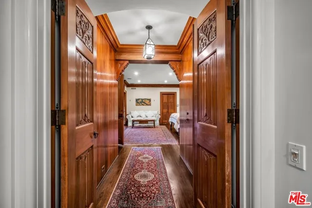 a front view of a house with a yard and potted plants