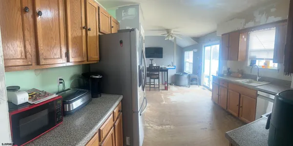 a view of a hallway with workspace and living room