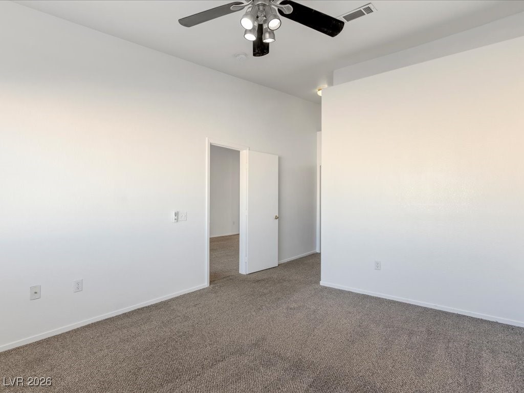 8725 West Flamingo Road, Unit 235 Las Vegas, NV 89147 - Photo 11 of 22 Unfurnished room featuring carpet floors and a ceiling fan