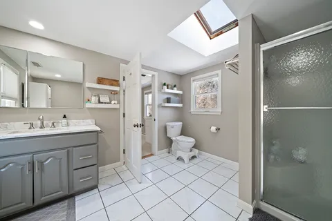 a bedroom with a bed and a bathroom