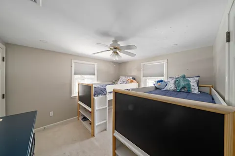 a view of a dining room with furniture and a chandelier fan