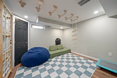 a bedroom with a bed and a painting on the wall