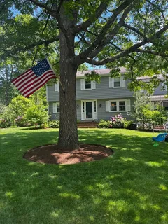 a front view of a house with a garden