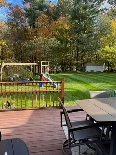 a view of a deck with furniture and garden