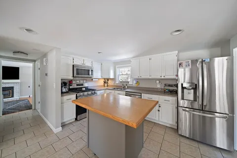 a kitchen with stainless steel appliances a refrigerator stove microwave and sink