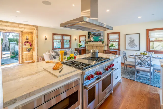 a kitchen that has a stove and a wooden floor