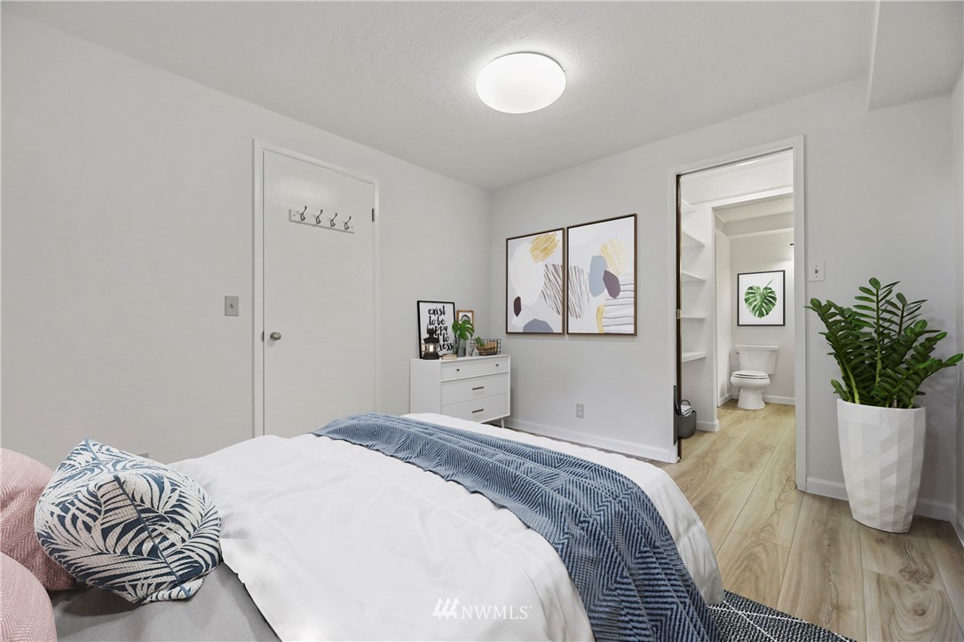 316 158th Place Southeast Bellevue, WA 98008 - Photo 19 of 29 a bedroom with a bed and wooden floor