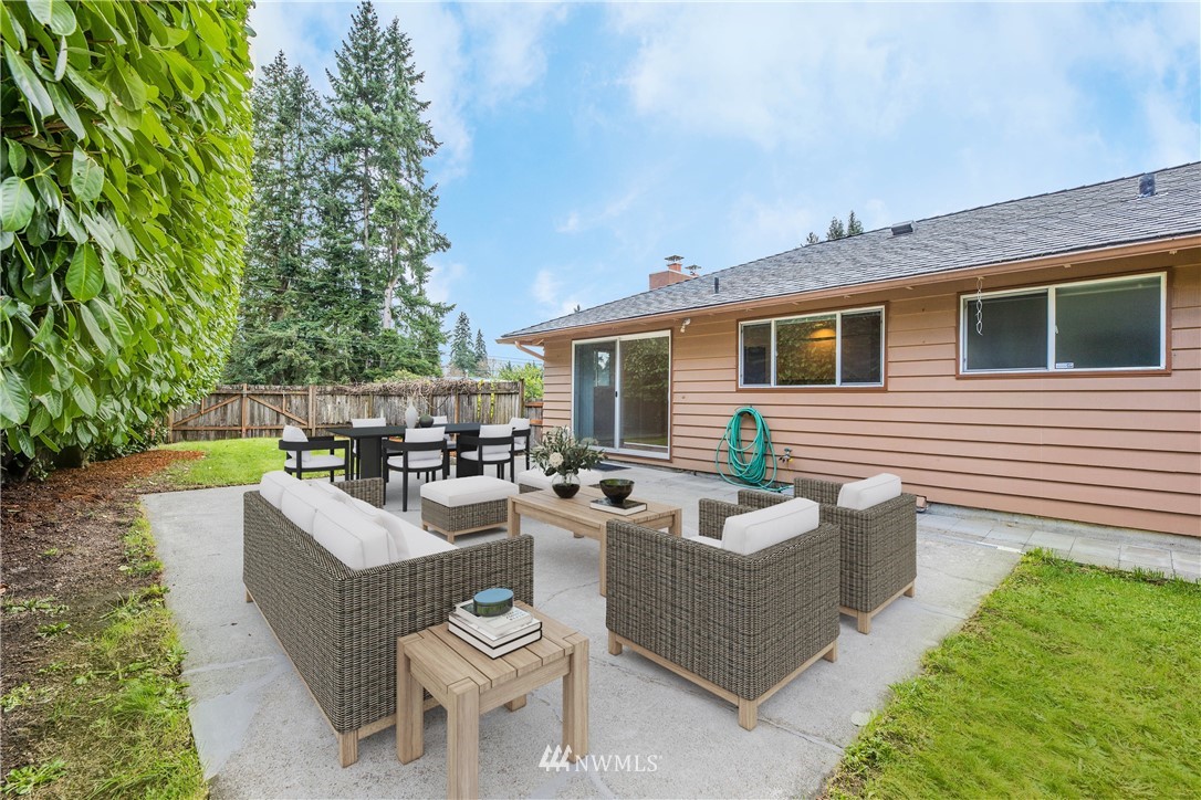 316 158th Place Southeast Bellevue, WA 98008 - Photo 23 of 29 a view of a patio with couches table and chairs with plants and trees
