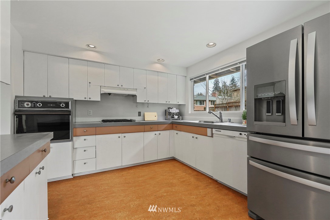 316 158th Place Southeast Bellevue, WA 98008 - Photo 8 of 29 a kitchen with a sink stove and refrigerator