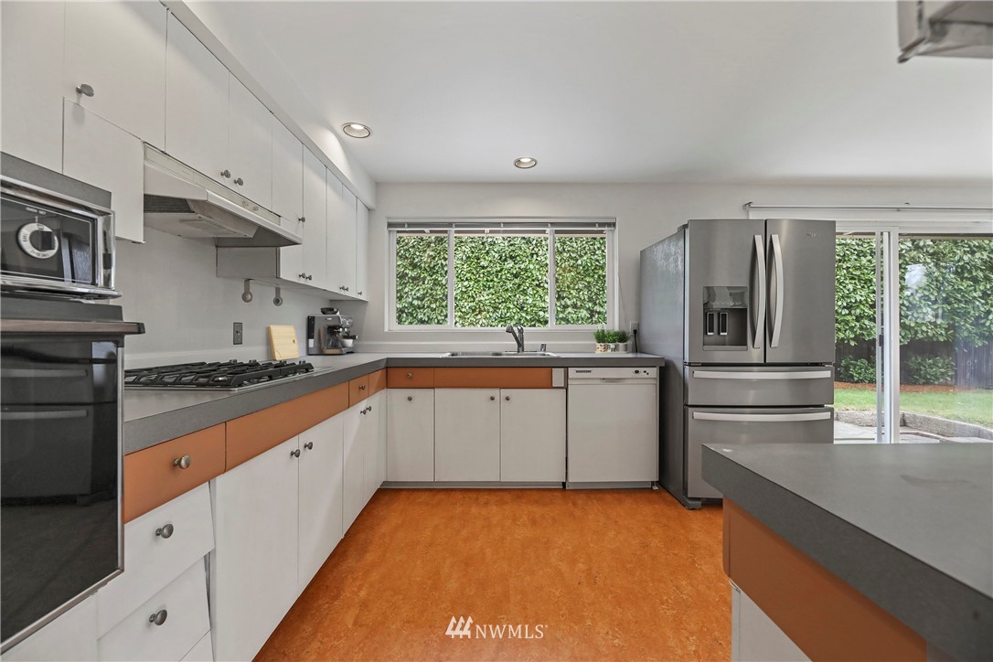 316 158th Place Southeast Bellevue, WA 98008 - Photo 9 of 29 a kitchen with granite countertop a sink stainless steel appliances and cabinets