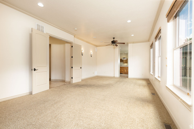 888 East Fiddlers Canyon Road Cedar City, UT 84721 - Photo 28 of 74 Spare room with light carpet, crown molding, recessed lighting, and a ceiling fan